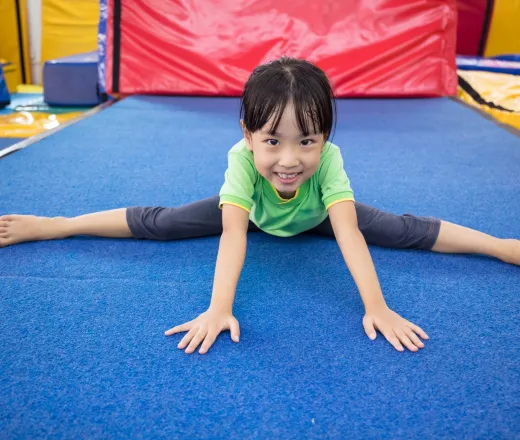 Little girl practicing gymnastics in a gymnastics center