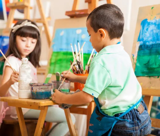 Little kids working on a painting